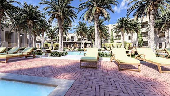 a pool area with lounge chairs and palm trees