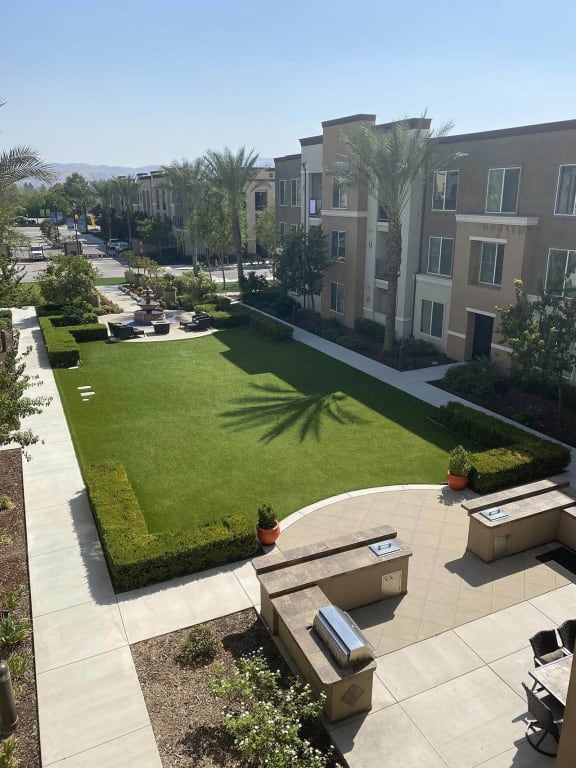 an aerial view of a yard with grass and a building