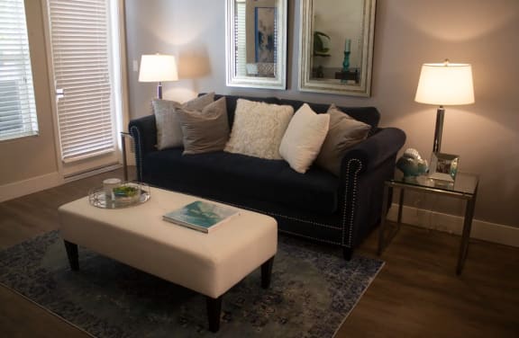 a living room with a black couch and a coffee table