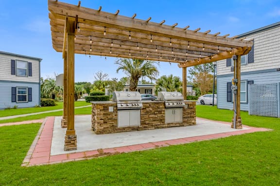 an outdoor kitchen with a pergola