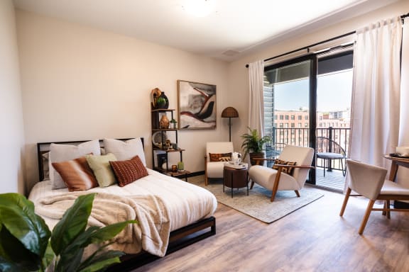 a bedroom with a bed and a sliding glass door to a balcony
