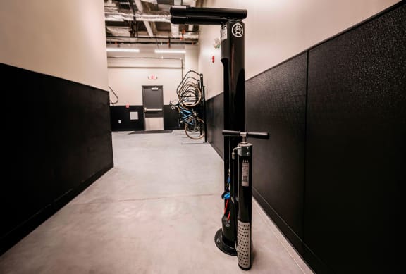 a bike rack in a room with black and white walls