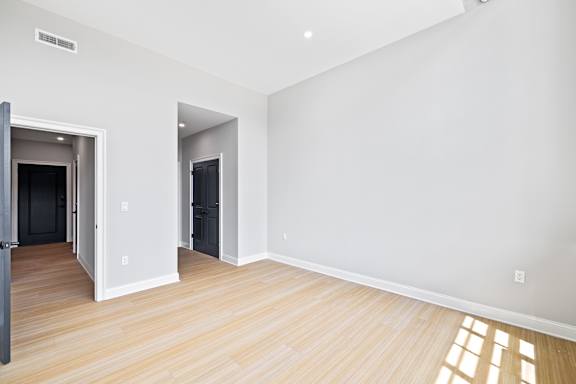 A room with a wooden floor and white walls.