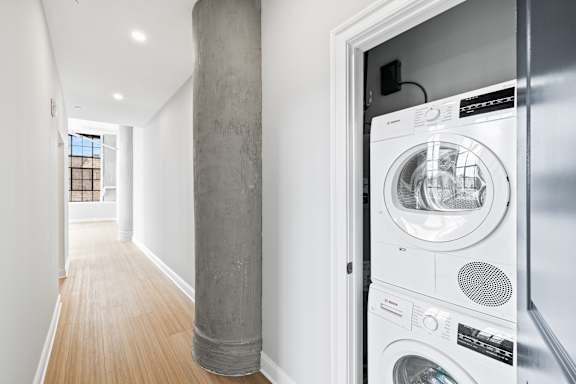 A washing machine is in a doorway.