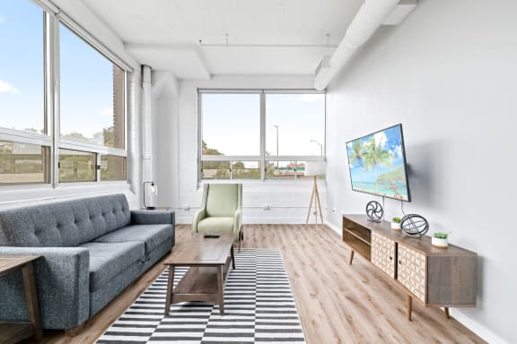 a living room with a large window and a tv on a stand