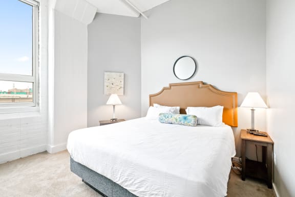 a bedroom with a bed and two nightstands