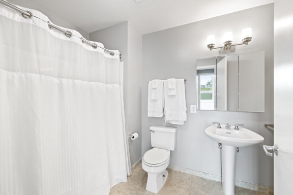 a bathroom with a toilet sink and shower