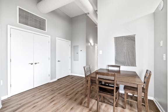 a dining room with a wooden table and chairs