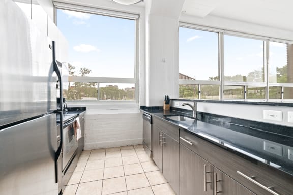 a kitchen with a large window and a view of the city
