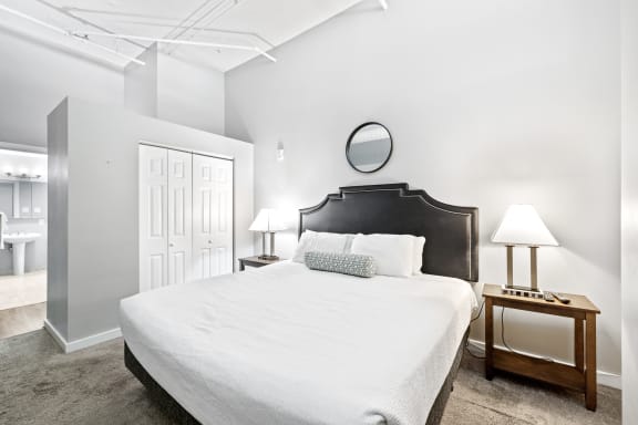 a bedroom with a bed and two nightstands