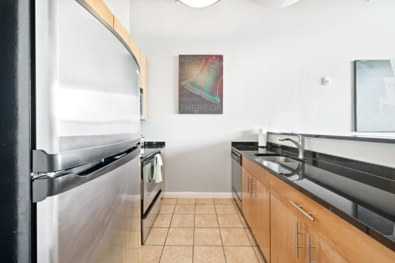 a kitchen with stainless steel appliances and white walls