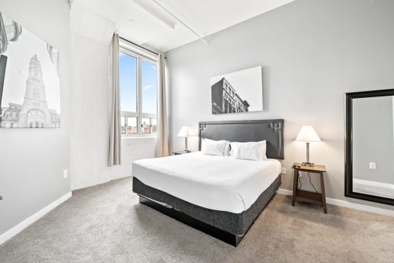 a bedroom with a large bed and a window