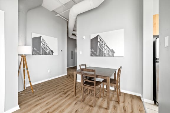 a dining room with a wooden table and chairs