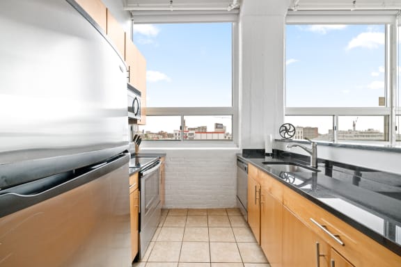 a kitchen with a large window and a view of the city