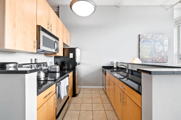 a kitchen with wooden cabinets and black appliances
