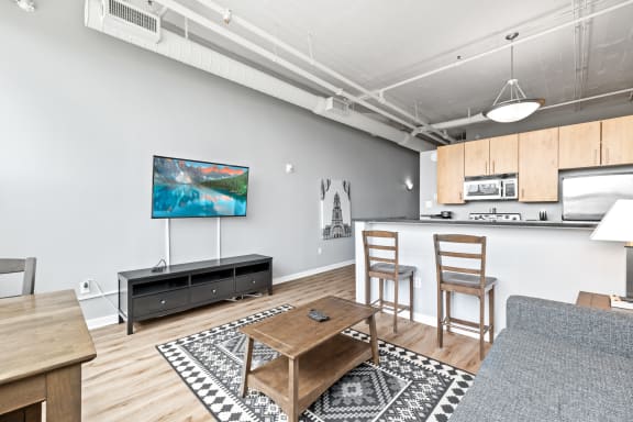 a living room with a coffee table and two chairs
