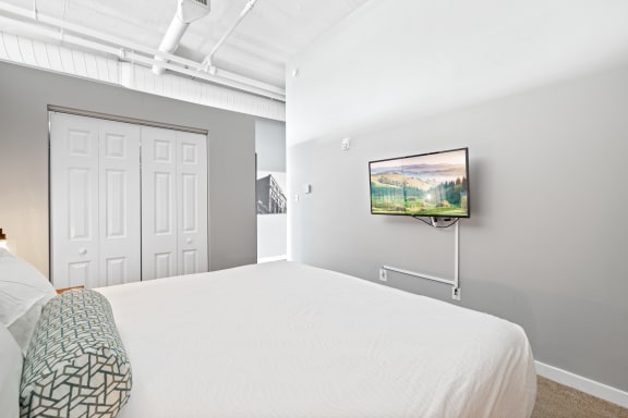 a bedroom with a large bed and a flat screen tv