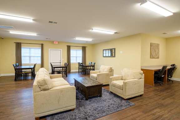 A living room with a white couch and a brown coffee table. at Timberland Park Apartments, Charlottesville, VA
