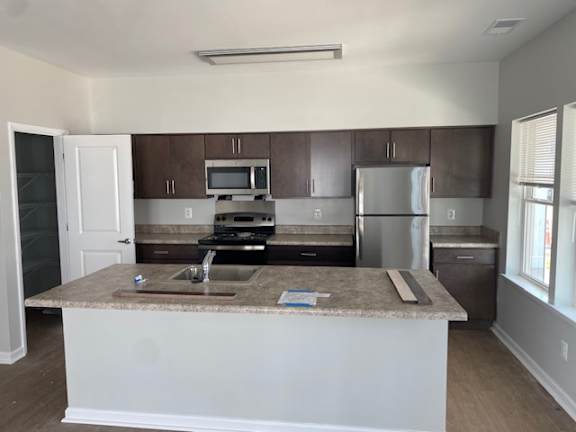 a kitchen with a counter top and a refrigerator