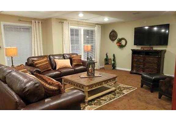 Living Room with Brown Leather Couch at Renaissance at Antiquity LLC, Cornelius, North Carolina
