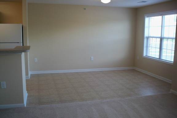 A room with a window and a carpeted floor at Greylin Ridge Apartments, North Carolina