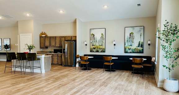 A modern kitchen with a dining area and a living room.