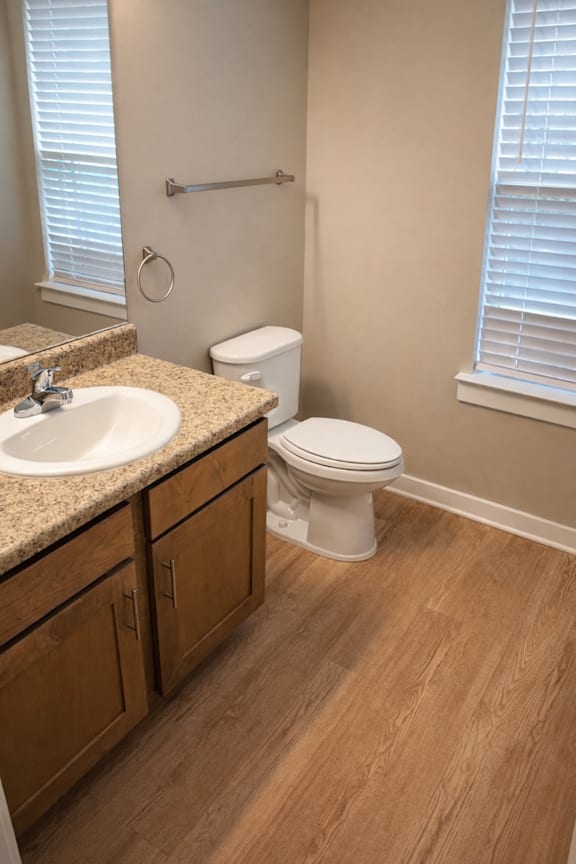 A white toilet sits next to a sink in a bathroom.