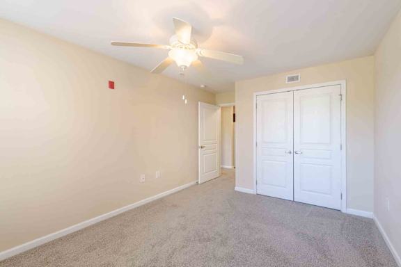 A room with a ceiling fan and carpeted floor at Granite Falls Apartments, North Carolina, 27571