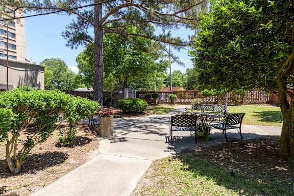 A park with a bench and a tree at Kinston Hotel Apartments, Kinston, 28501.