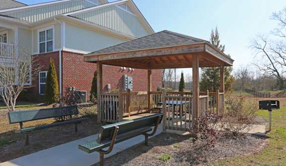 Gazebo with a wooden roof is surrounded by benches and plants at Cooper Terrace in Elkin, NC 28621