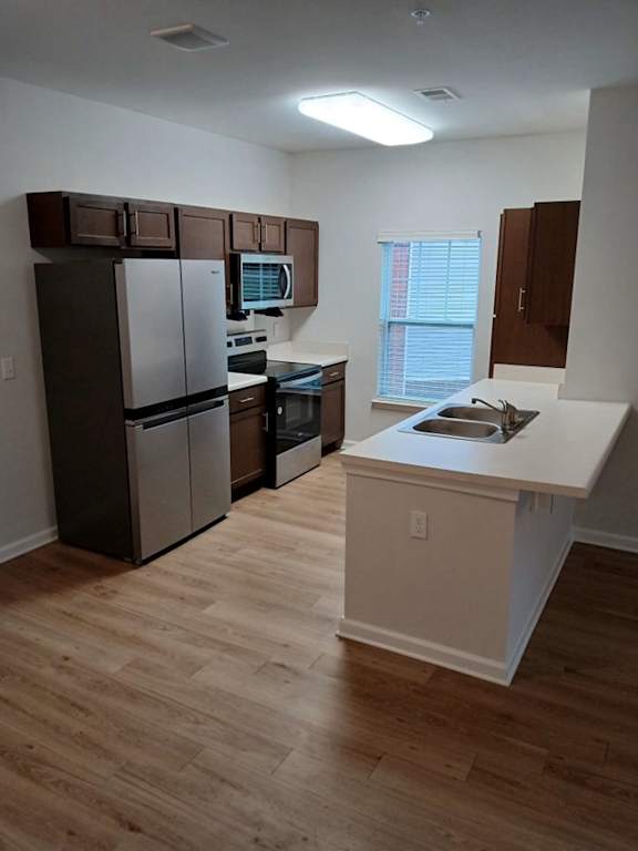 Kitchen with wooden floors and a white counter at The Assembly II in 29611
