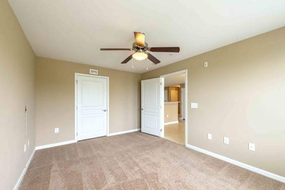 A room with a ceiling fan and carpeted floor. at The Grande at Granite Falls LLC Apartments, North Carolina