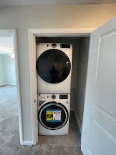a white washer and dryer in a small closet