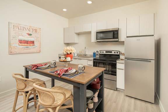 A kitchen with a table set for a meal.