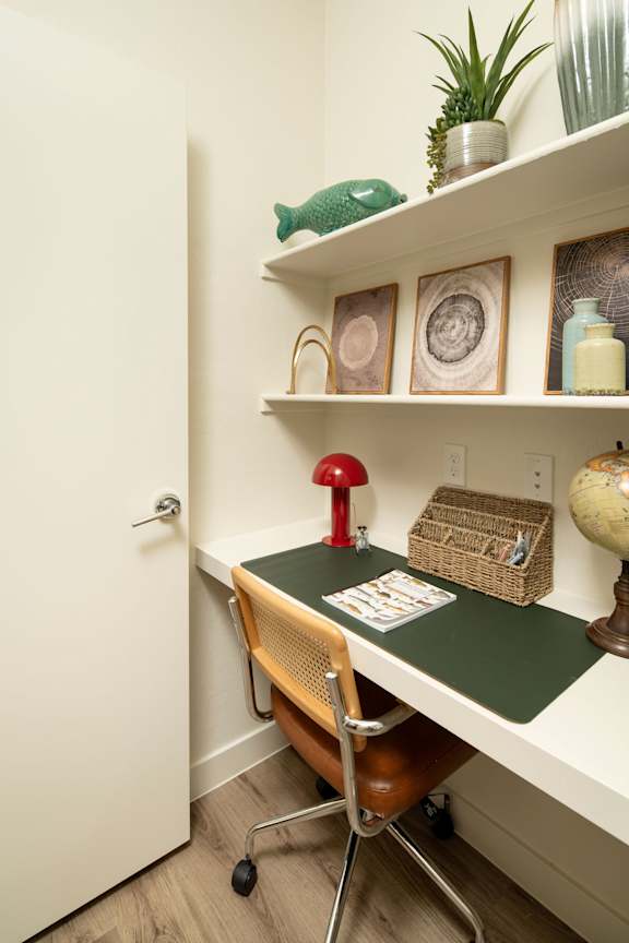 A small room with a desk and chair.