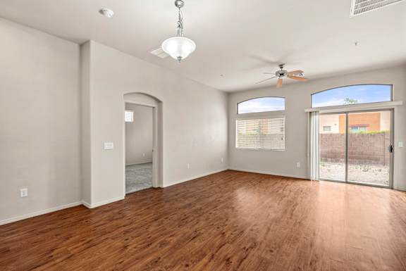 A room with wooden floors and a ceiling fan.