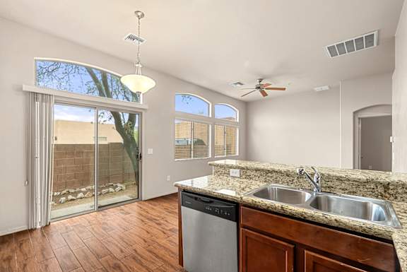 A kitchen with a wooden counter and a dishwasher.