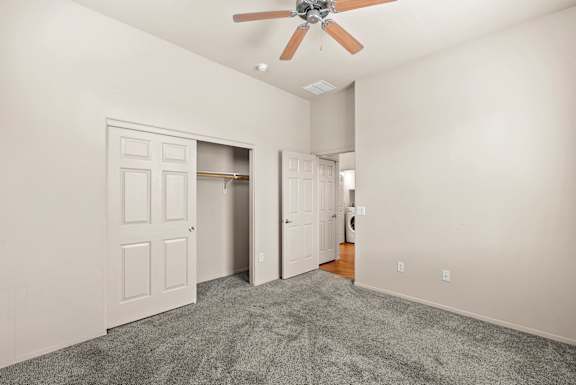 A room with a ceiling fan and two doors.