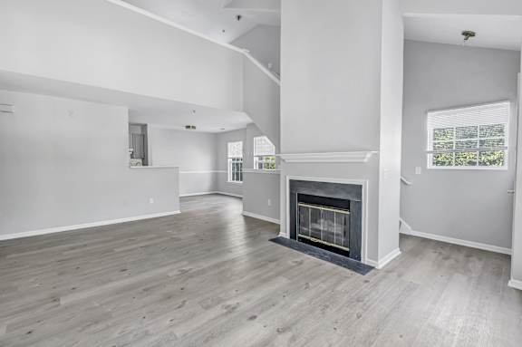 A spacious living room with a fireplace and hardwood floors. at Ardenwood Apartments, Connecticut, 06473