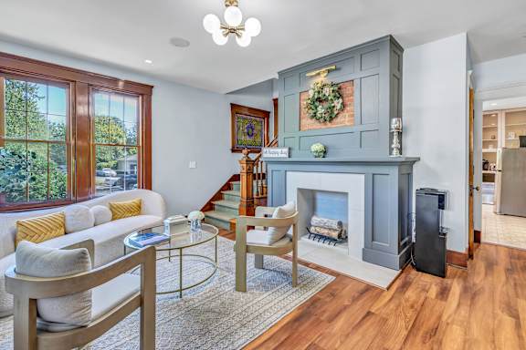 A living room with a fireplace and a couch. at Ardenwood Apartments, Connecticut, 06473
