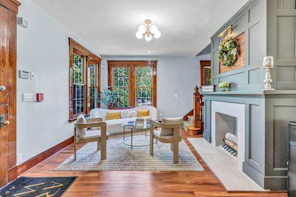 A living room with a fireplace and a dining table. at Ardenwood Apartments, North Haven, Connecticut, 06473