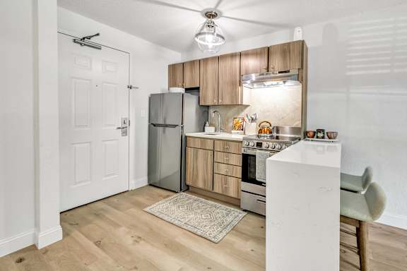 a kitchen with wooden cabinets and stainless steel appliances