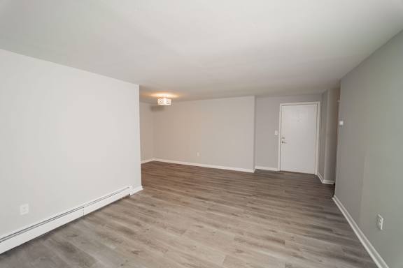 an empty living room with wood floors and white walls  at Enclave West Hartford / Parc West, West Hartford, CT