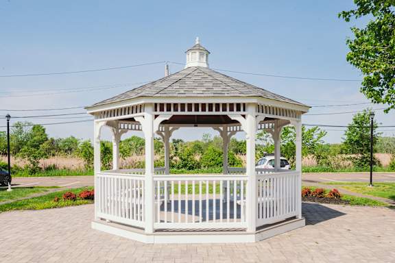 a white gazebo with a cupola and a brick sidewalk at Encore 99, Connecticut, 06512