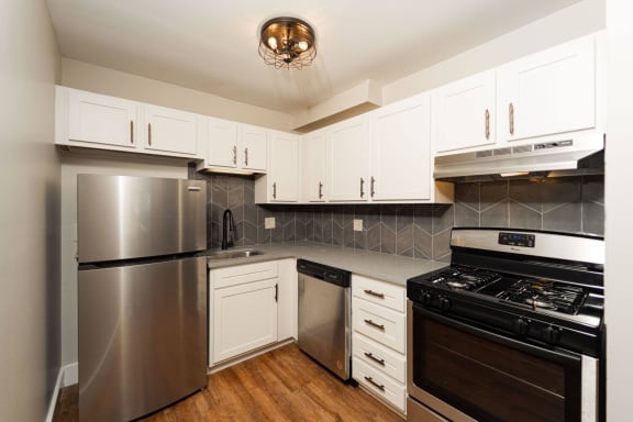 a kitchen with white cabinets at Retro 511 Apartments, Connecticut