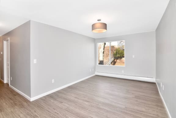 an empty living room with white walls and a window&#xA0;at Springwood Gardens, New Britain, Connecticut
