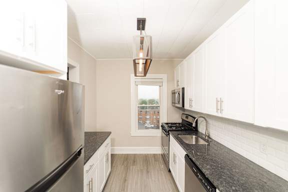 a kitchen with granite counter tops and stainless steel appliances
