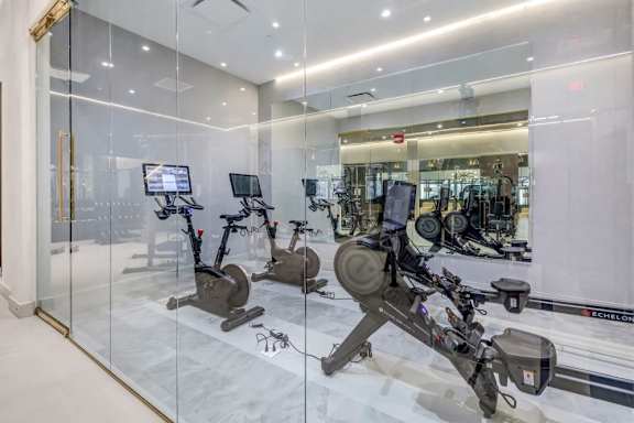 a gym with cardio equipment and glass walls at Up House, Connecticut, 06032