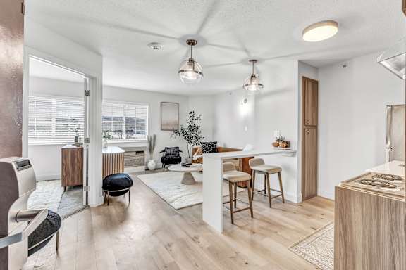 a living room with a kitchen and a dining room
