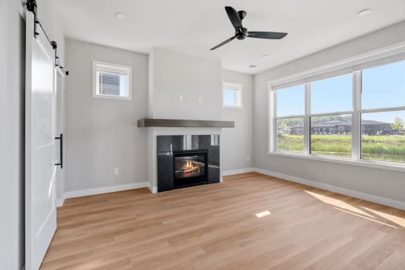 an empty living room with a fireplace and a window
